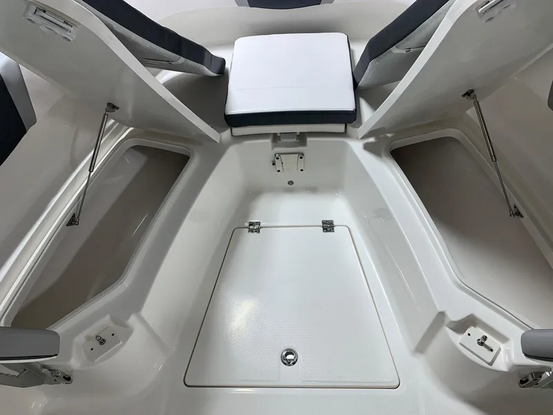 Slide: The Image of 2026 Robalo R270 boat interior with open storage compartments and cushioned seating. - 11