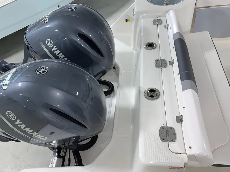 Slide: The Image of 2026 Robalo R270 boat with dual Yamaha outboard engines, white deck view. - 15