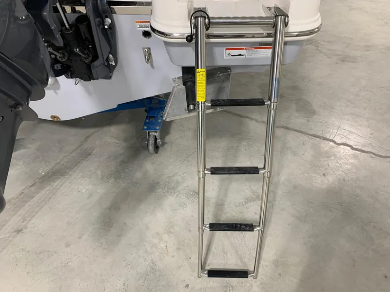 Slide: The Image of Stainless steel ladder on 2026 Robalo R270 boat, resting on concrete floor. - 4