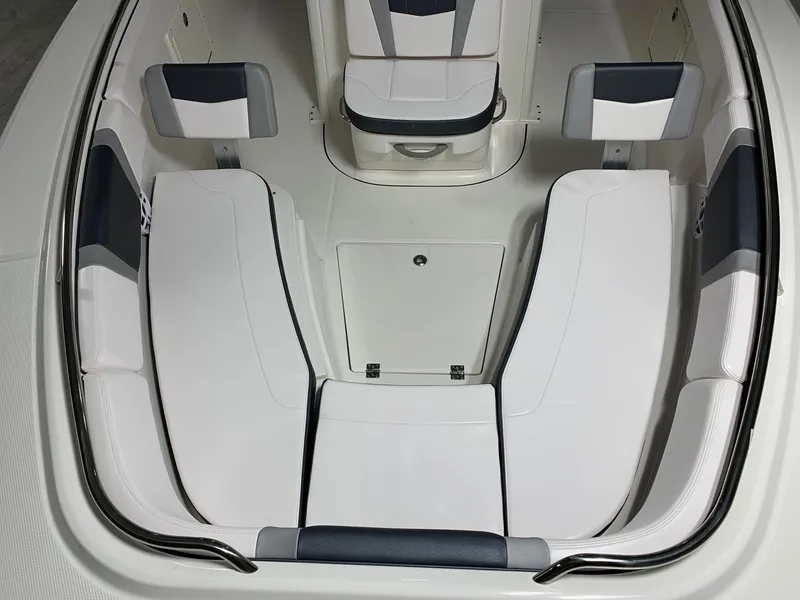 Slide: The Image of 2026 Robalo R270 boat interior with white cushioned seating and storage compartments. - 7