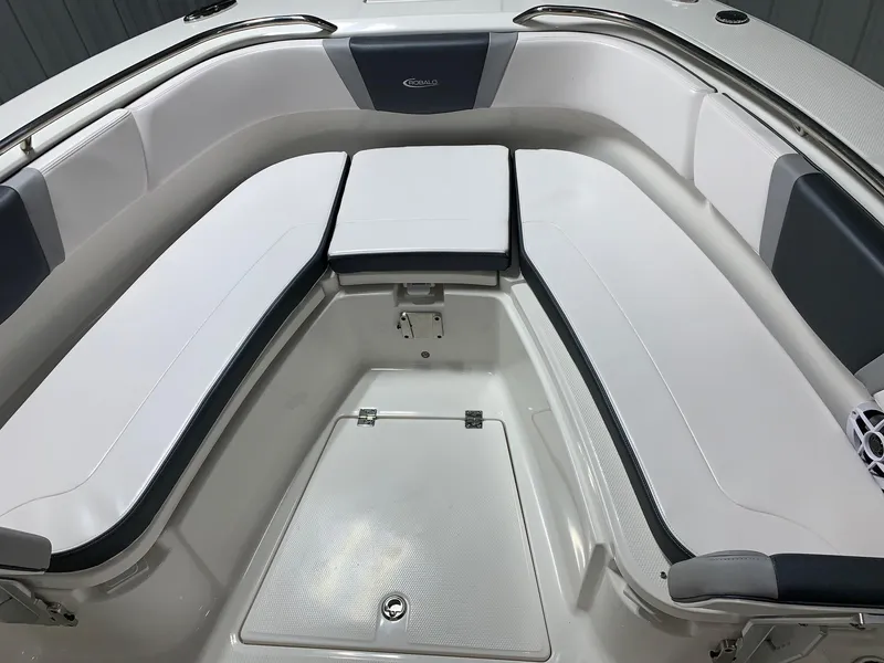 Slide: The Image of 2026 Robalo R270 boat interior with white cushioned seating and storage compartments. - 9