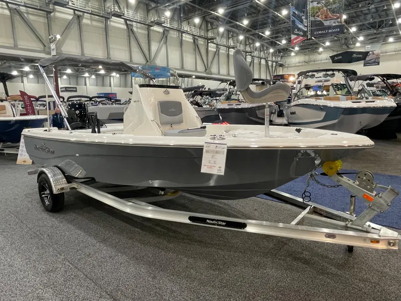 The Image of 2023 NauticStar 195 Bay boat displayed indoors on a trailer. - 0