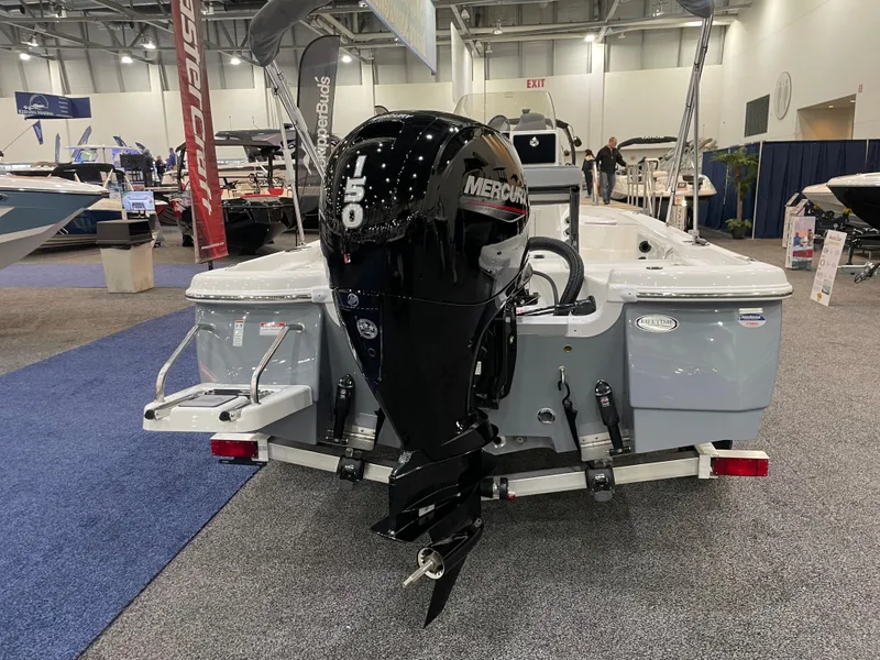 Slide: The Image of 2023 NauticStar 195 Bay boat with Mercury outboard motor at a boat show. - 2