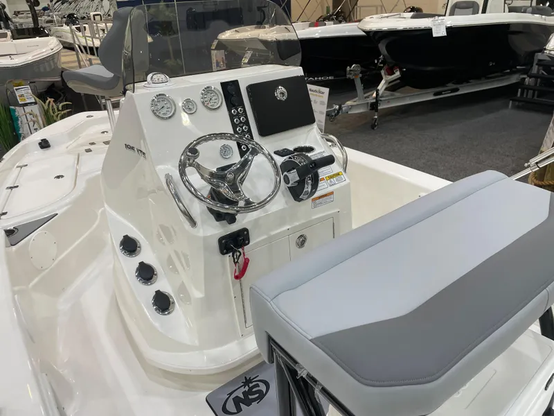Slide: The Image of 2023 NauticStar 195 Bay boat interior with steering console and seating. - 4