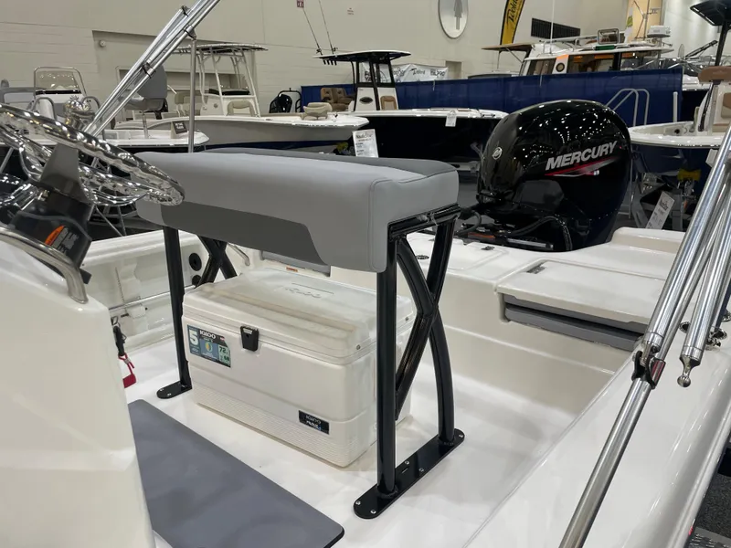 Slide: The Image of 2023 NauticStar 195 Bay boat interior with Mercury engine and seating area. - 5