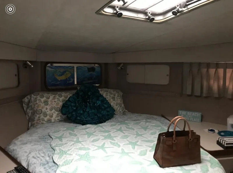 Slide: The Image of Cozy cabin interior of 1986 Trojan 14 Meter yacht with bed and porthole. - 3