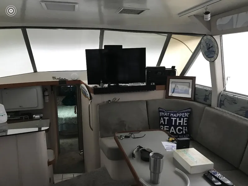 Slide: The Image of Interior of a 1986 Trojan 14 Meter yacht with cozy seating and modern amenities. - 5