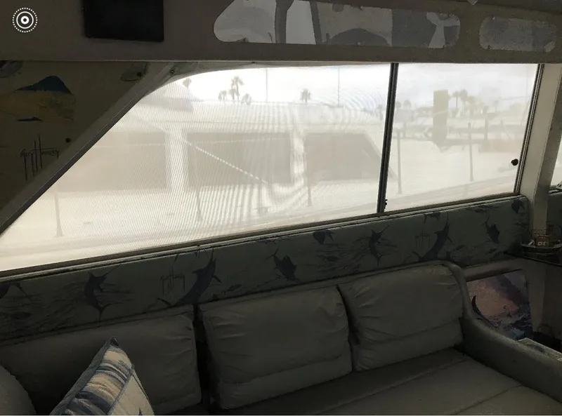 Slide: The Image of Interior of a 1986 Trojan 14 Meter yacht with cushioned seating and large windows. - 6