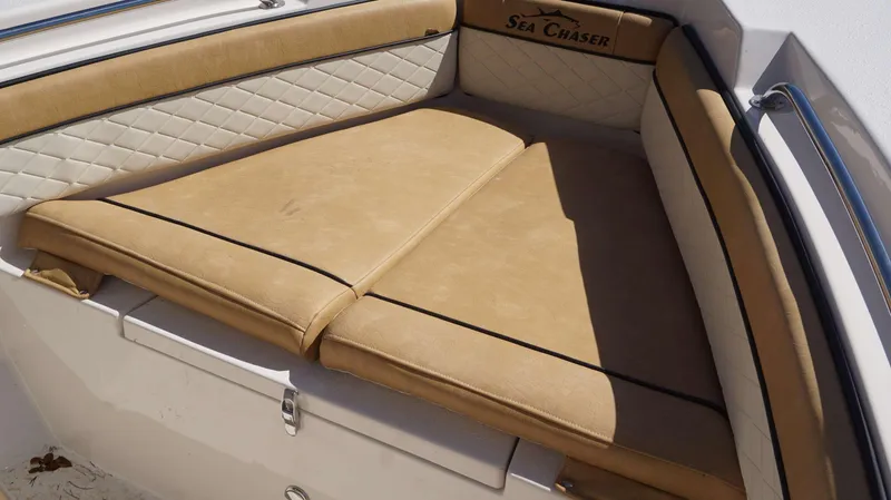 Slide: The Image of 2023 Sea Chaser 20 HFC boat with tan cushioned seating and diamond-stitched backrest. - 11