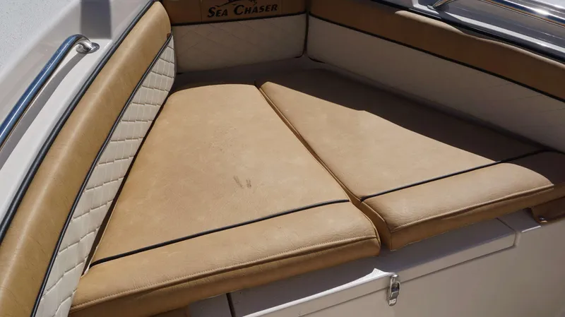 Slide: The Image of 2023 Sea Chaser 20 HFC boat with tan cushioned seating and white diamond-stitched backrest. - 12