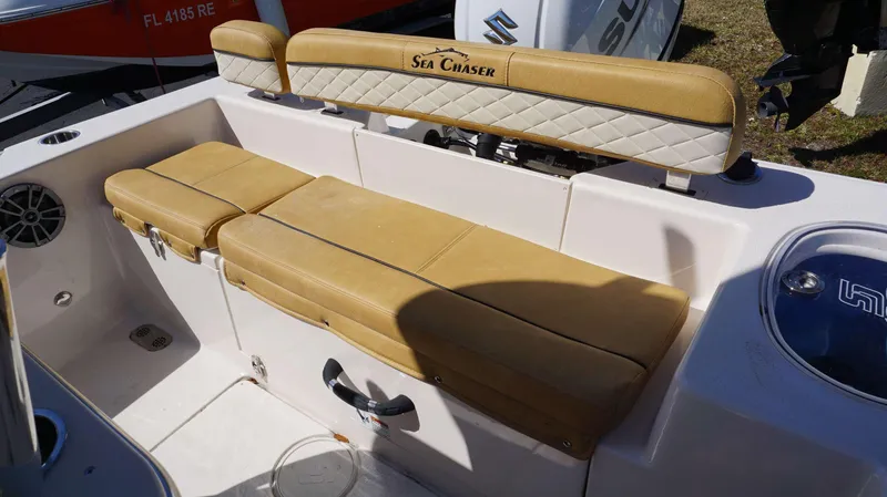 Slide: The Image of 2023 Sea Chaser 20 HFC boat with tan cushioned seating and storage compartments. - 16