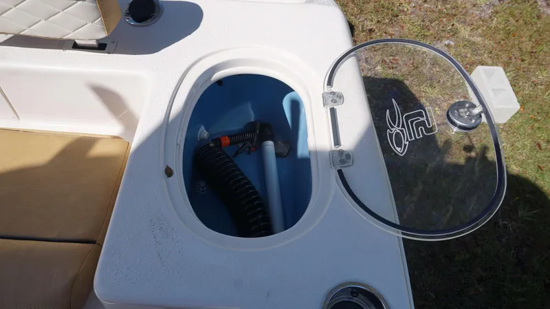 Slide: The Image of Open storage compartment on a 2023 Sea Chaser 20 HFC boat with equipment inside. - 18