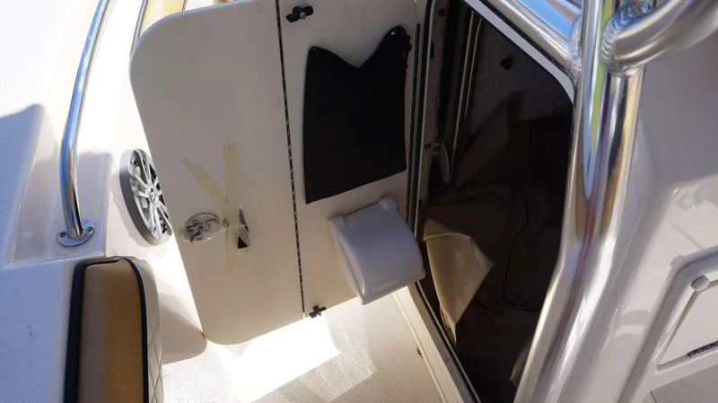 Slide: The Image of 2023 Sea Chaser 20 HFC boat interior storage compartment with speaker and railing. - 9