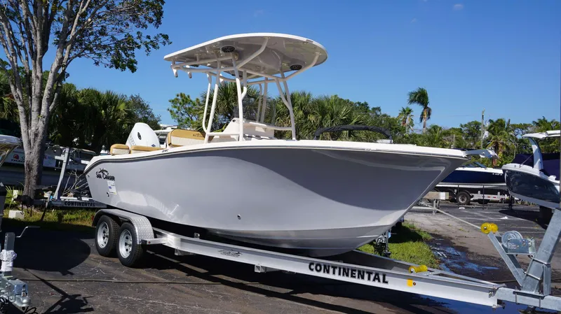 Slide: The Image of 2023 Sea Chaser 22 HFC boat on a Continental trailer, parked outdoors. - 1