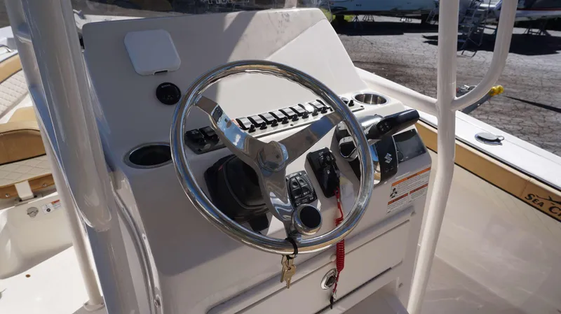 Slide: The Image of 2023 Sea Chaser 22 HFC boat console with steering wheel and controls. - 12