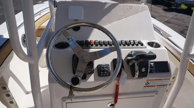 Slide: The Image of 2023 Sea Chaser 22 HFC boat helm with steering wheel and control panel. - 13