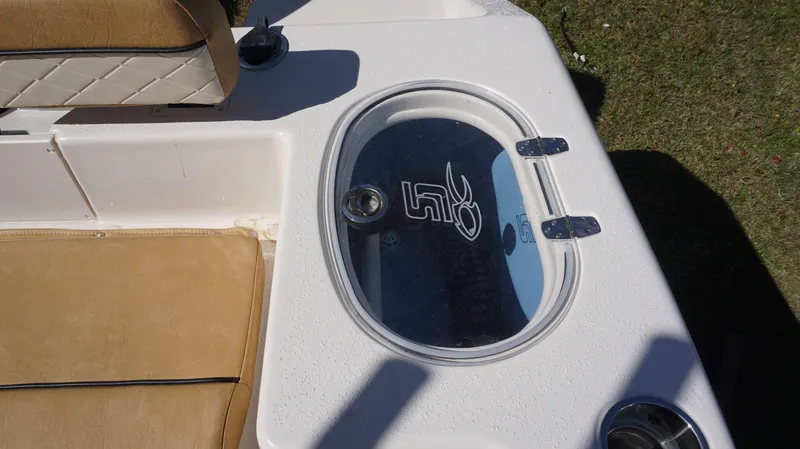 Slide: The Image of 2023 Sea Chaser 22 HFC boat with tan seating and oval hatch. - 14