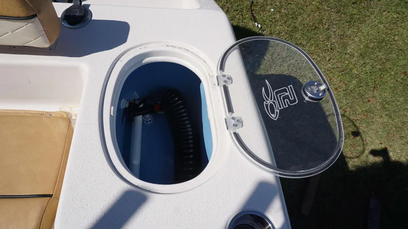 Slide: The Image of Open storage compartment on 2023 Sea Chaser 22 HFC boat, featuring a clear lid. - 15