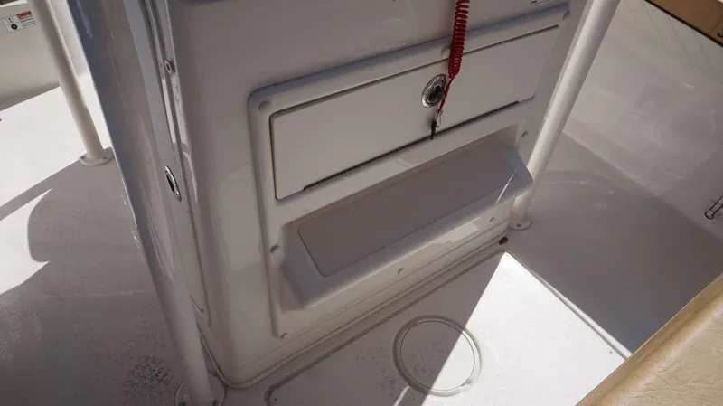 Slide: The Image of 2023 Sea Chaser 22 HFC boat interior with storage compartment and safety features. - 16
