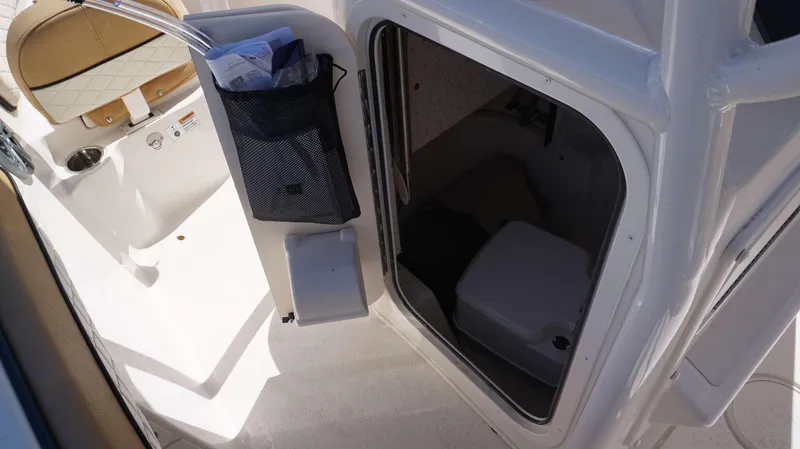 Slide: The Image of 2023 Sea Chaser 22 HFC boat interior with storage compartment and seating. - 18