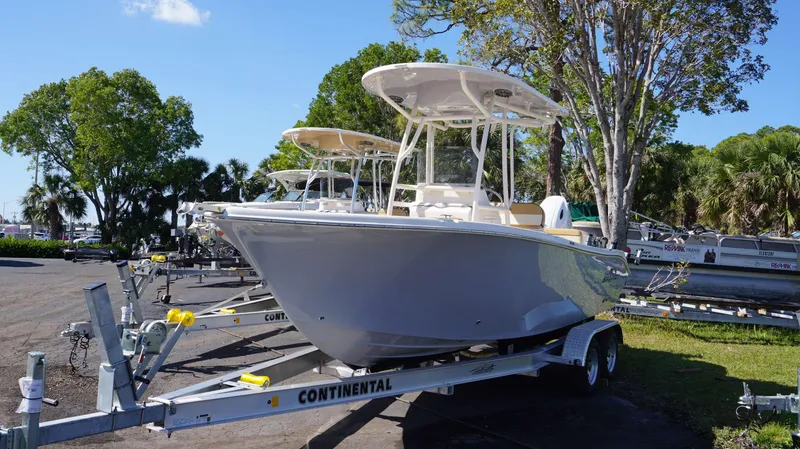 Slide: The Image of 2023 Sea Chaser 22 HFC boat on a Continental trailer in a marina. - 2