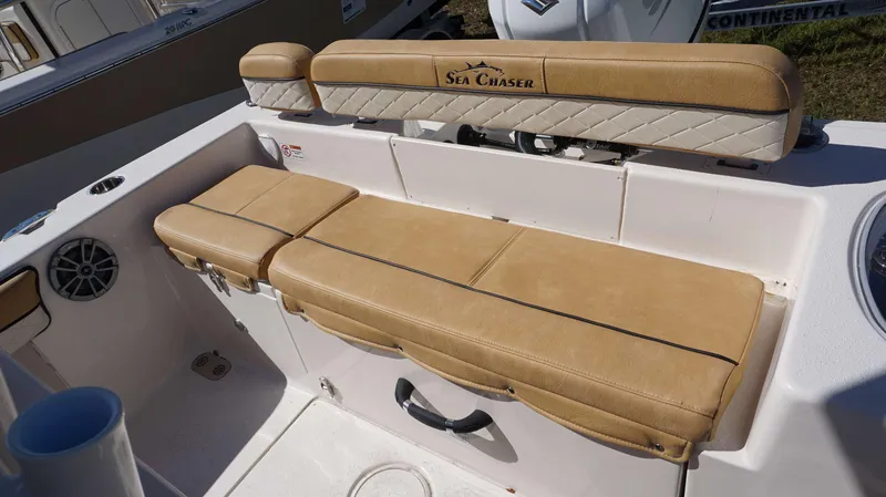 Slide: The Image of 2023 Sea Chaser 22 HFC boat seating area with tan upholstery and storage compartments. - 20