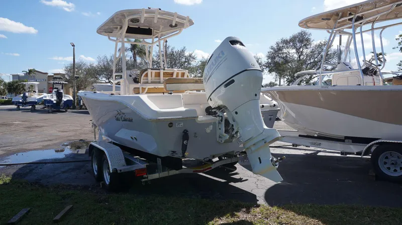Slide: The Image of 2023 Sea Chaser 22 HFC boat on trailer, parked outdoors under clear sky. - 4