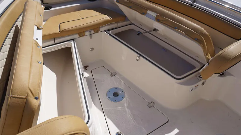 Slide: The Image of 2023 Sea Chaser 22 HFC boat interior with tan seating and storage compartments. - 8