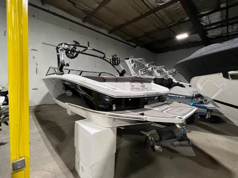 Slide: The Image of Interior of a 2019 Cobalt CS23 Surf boat with beige seating. - 18