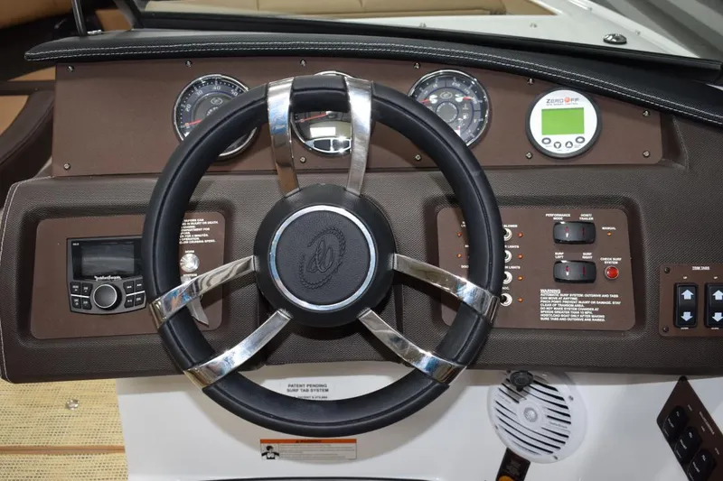 Slide: The Image of Rear view of a 2019 Cobalt CS23 Surf boat in a shipyard. - 6