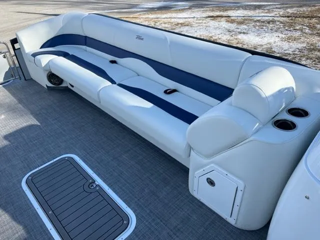 Slide: The Image of 2023 JC 25 Neptoon pontoon boat with white and blue seating, cup holders, and storage. - 4