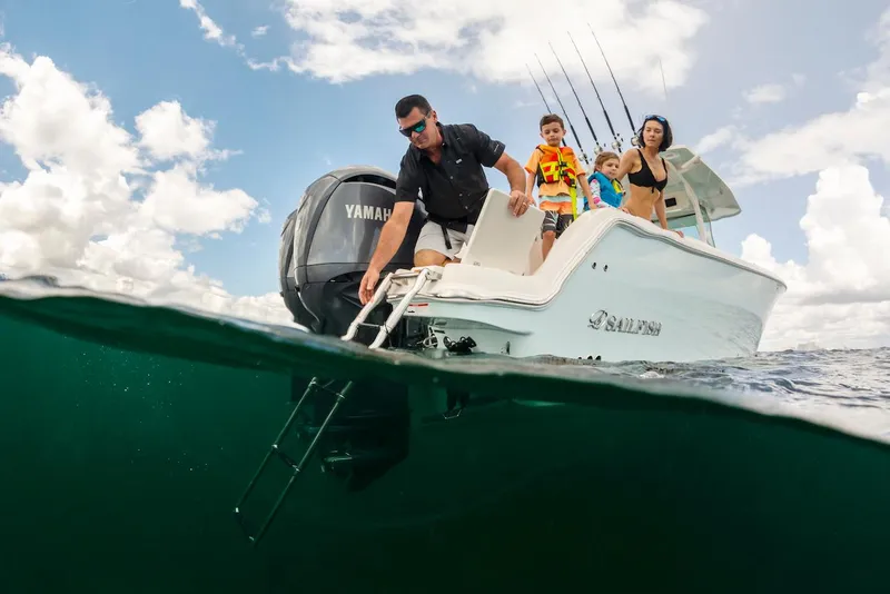 Slide: The Image of Family enjoying a day on a 2024 Sailfish 312 CC boat, ocean view. - 10