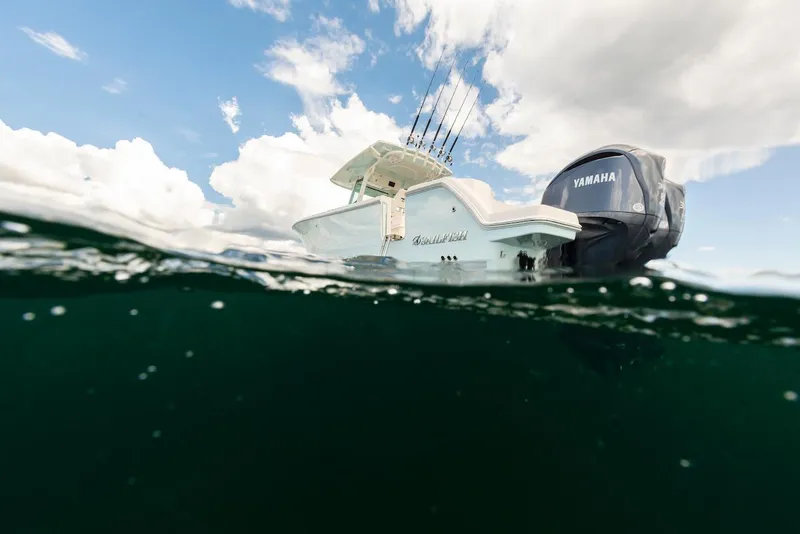 Slide: The Image of 2024 Sailfish 312 CC boat with Yamaha engine on water, under cloudy sky. - 13