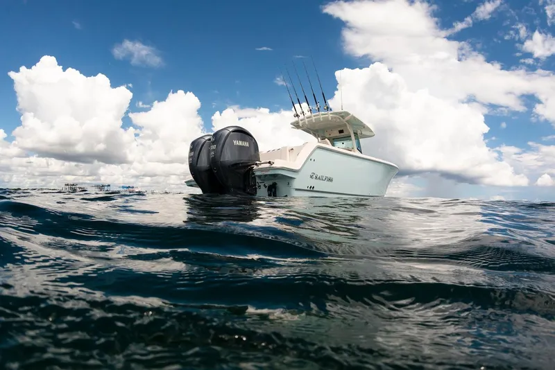 Slide: The Image of 2024 Sailfish 312 CC boat on ocean, Yamaha engines, under cloudy sky. - 15