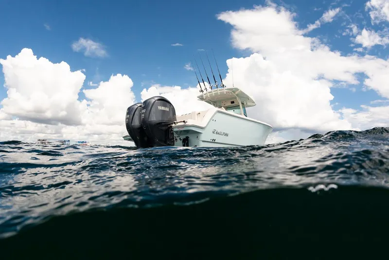 Slide: The Image of 2024 Sailfish 312 CC boat on open water under a cloudy sky. - 16
