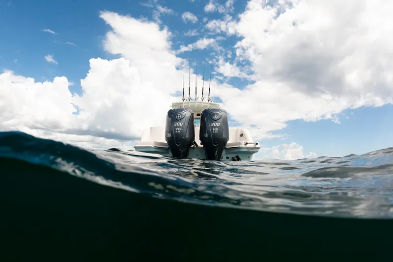 Slide: The Image of 2024 Sailfish 312 CC boat with dual engines on open water. - 18