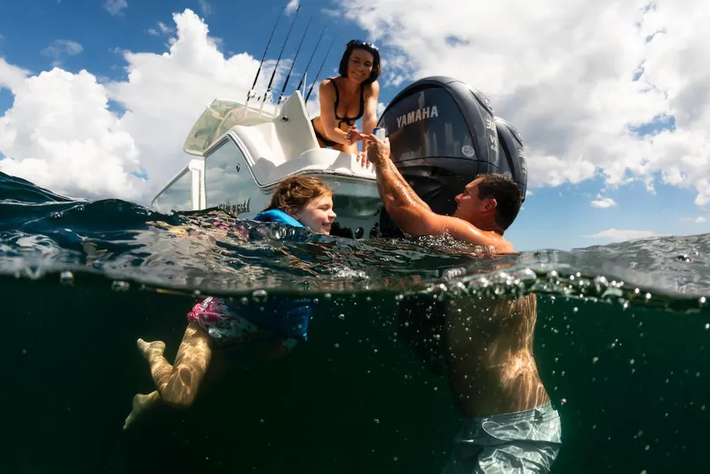 Slide: The Image of Family enjoying water near 2024 Sailfish 312 CC boat. - 19