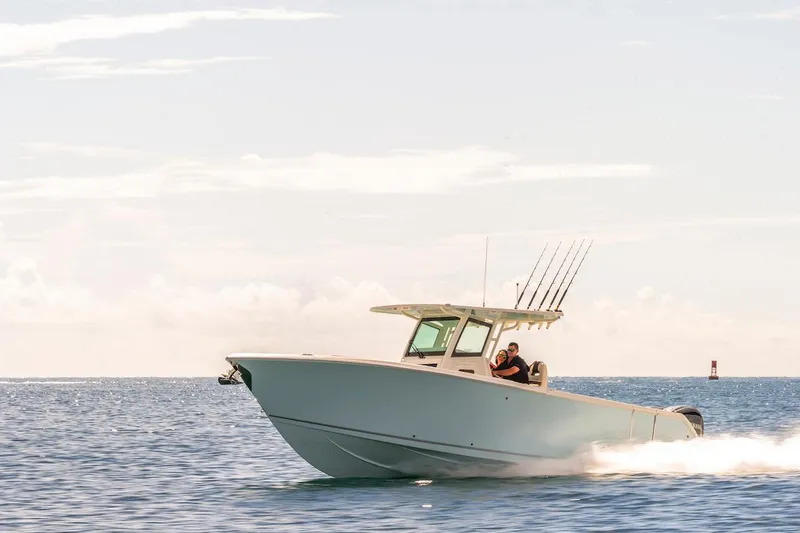 Slide: The Image of 2024 Sailfish 312 CC boat cruising on open water. - 2