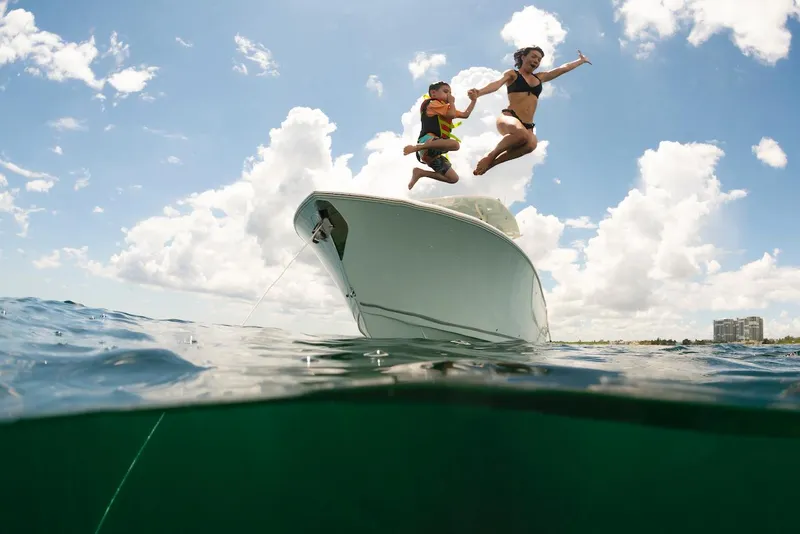 Slide: The Image of People jumping off 2024 Sailfish 312 CC boat into the ocean. - 28