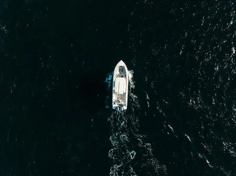 Slide: The Image of Aerial view of 2024 Sailfish 312 CC boat cruising on dark ocean waters. - 31