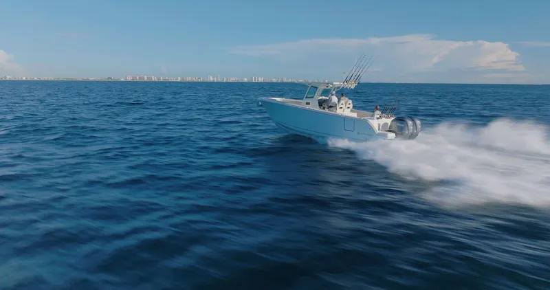 Slide: The Image of 2024 Sailfish 312 CC boat speeding on open ocean waters. - 47