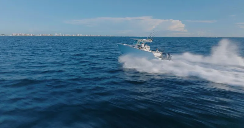 Slide: The Image of 2024 Sailfish 312 CC speeding across open ocean waters. - 48