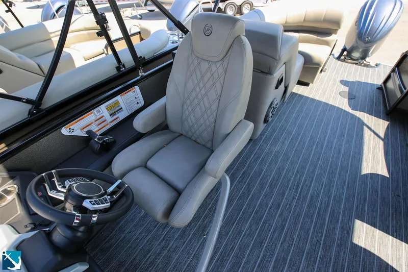 Slide: The Image of 2023 Premier 250 Intrigue RF boat interior with captain's chair and steering console. - 10