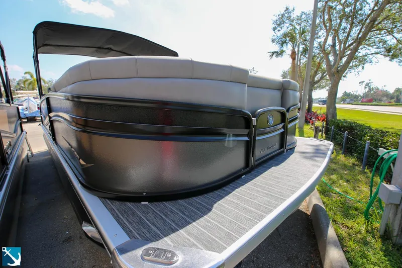 Slide: The Image of 2023 Premier 250 Intrigue RF pontoon boat, front view, docked outdoors. - 2