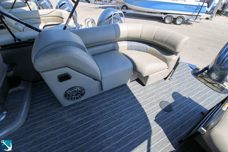 Slide: The Image of 2023 Premier 250 Intrigue RF boat interior with gray seating and striped flooring. - 7