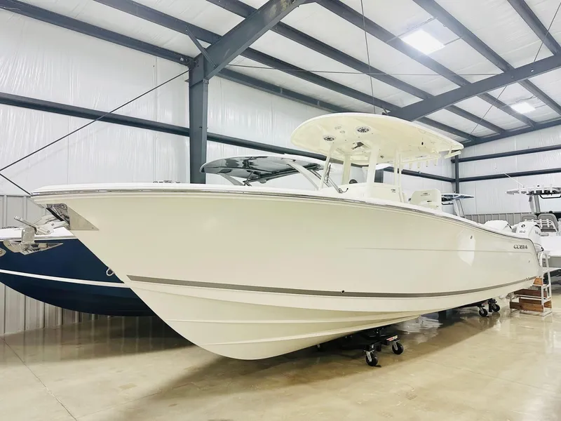 Slide: The Image of 2024 Cobia 280 CC boat in indoor storage facility. - 0