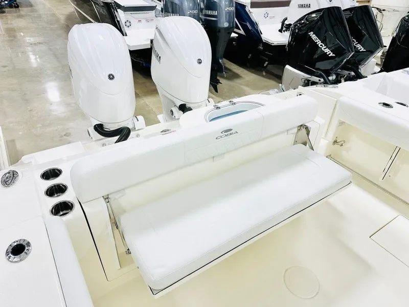 Slide: The Image of 2024 Cobia 280 CC boat with dual outboard engines and spacious seating. - 11