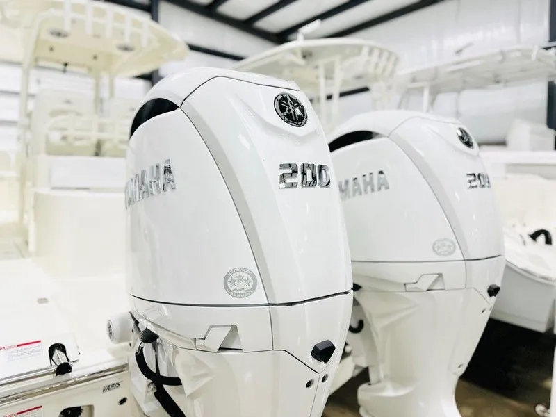 Slide: The Image of 2024 Cobia 280 CC with twin Yamaha 200 engines in a showroom. - 15