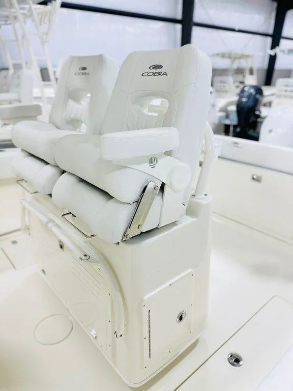Slide: The Image of 2024 Cobia 280 CC boat with white cushioned seating in a sleek interior. - 2