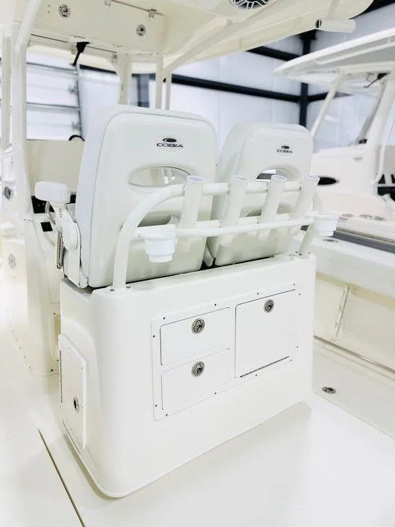 Slide: The Image of 2024 Cobia 280 CC boat interior with white seating and storage compartments. - 3